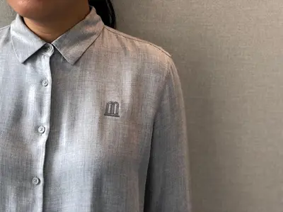 a man wearing a gray shirt and a tie at The Blanket Hotel Phuket Old Town in Phuket Town