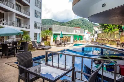 a view of the pool at a resort with tables and chairs at Wazza's Patong Apartment, Smart TV and Fast Wi-Fi in Patong Beach