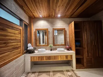 a bathroom with two sinks and a mirror at Viking Nature Resort in Phi Phi Don