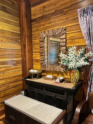 a room with a table and a mirror in a log cabin at Viking Nature Resort in Phi Phi Don