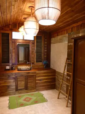 a bathroom with wooden walls and a large mirror at Viking Nature Resort in Phi Phi Don