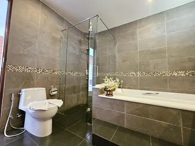 a bathroom with a toilet and a shower and a tub at JJ Queen Villa and Spa Kohyaonoi in Ko Yao Noi
