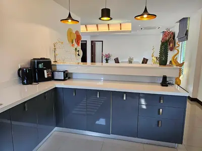 a kitchen with blue cabinets and a counter top at JJ Queen Villa and Spa Kohyaonoi in Ko Yao Noi