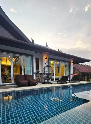 a house with a swimming pool next to a house at JJ Queen Villa and Spa Kohyaonoi in Ko Yao Noi