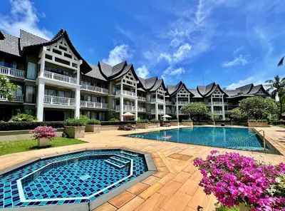 a large apartment building with a swimming pool at Allamanda Laguna Phuket by RESAVA in Bang Tao Beach