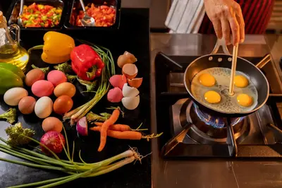 a person cooking eggs in a pan on a stove at WOOVO Phuket Patong - by Swandor in Patong Beach