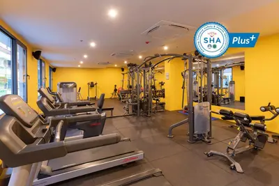 a gym with treadmills and cardio equipment in a room at WOOVO Phuket Patong - by Swandor in Patong Beach