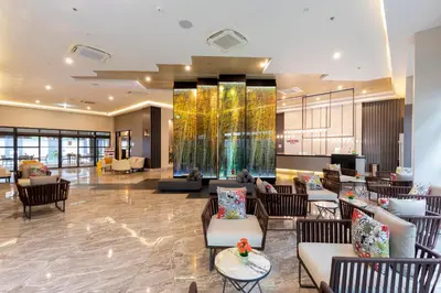 a lobby of a hotel with couches and chairs at WOOVO Phuket Patong - by Swandor in Patong Beach
