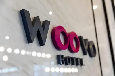 a sign for a wyno hotel on a wall at WOOVO Phuket Patong - by Swandor in Patong Beach
