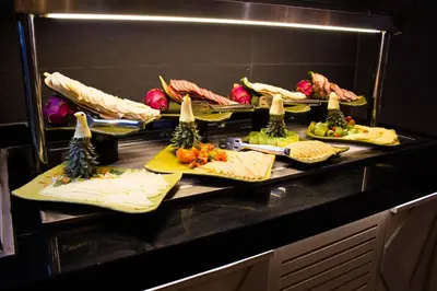 a buffet line with different types of food on plates at WOOVO Phuket Patong - by Swandor in Patong Beach