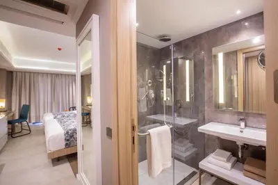 a bathroom with a shower and a sink and a mirror at WOOVO Phuket Patong - by Swandor in Patong Beach