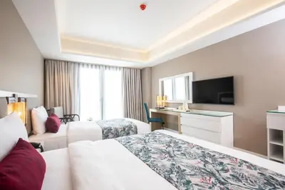 a hotel room with a bed and a tv at WOOVO Phuket Patong - by Swandor in Patong Beach