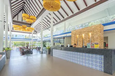 a lobby of a restaurant with a bar and tables at Homm Suites Laguna, part of Banyan Group in Bang Tao Beach