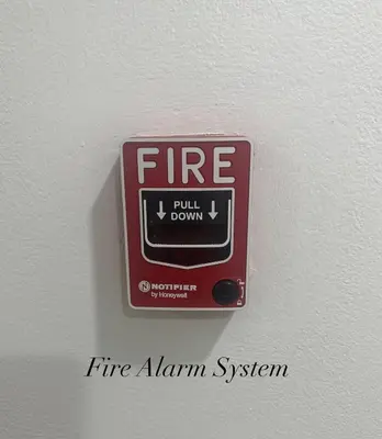 a fire alarm on a wall with the words fire alarm system at Surin Bay Inn in Surin Beach