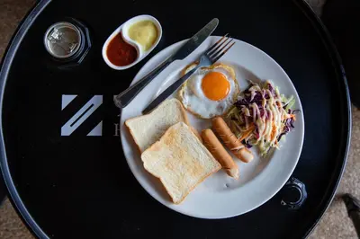 a plate of breakfast food with an egg and toast at The Z Nite Hostel in Phuket Town