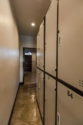 a row of lockers in a hallway with a door at The Z Nite Hostel in Phuket Town