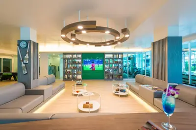 a large room with couches and a large chandelier at Katathani Phuket Beach Resort - SHA Extra Plus in Kata Beach