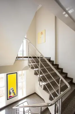 a spiral staircase in a building with a painting on the wall at Central Residences in Phuket Town