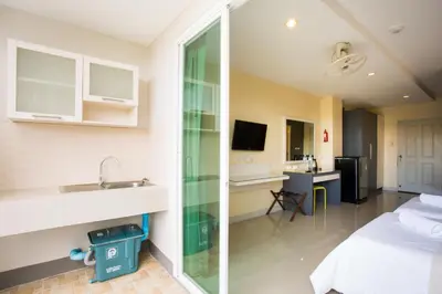 a hotel room with a bed and a sink at Central Residences in Phuket Town