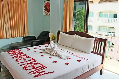 a bedroom with a bed with red roses on it at Baan Ketkeaw Guest House 2 in Patong Beach