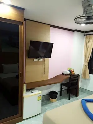 a room with a desk with a flat screen tv at Baan Ketkeaw Guest House 2 in Patong Beach