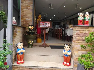 two chinese figurines standing in front of a store at Baan Ketkeaw Guest House 2 in Patong Beach