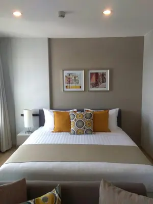 a bedroom with a large bed with pillows at Zcape at Bangtao in Bang Tao Beach