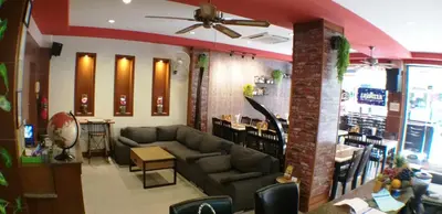 a living room with a couch and a bar at U Sabai Living Hotel in Patong Beach