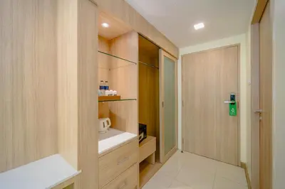 a small kitchen with wooden cabinets and a sink at Aonang Buri Resort in Ao Nang Beach