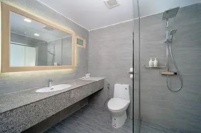 a bathroom with a toilet and a sink and a shower at Aonang Buri Resort in Ao Nang Beach