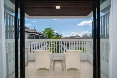 a patio with chairs and a table on a balcony at Aonang Buri Resort in Ao Nang Beach