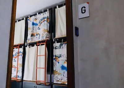 a row of curtains in a room with the g sign at TAN Hostel x Cafe , Aonang Beach in Ao Nang Beach