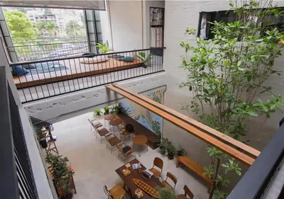 an overhead view of a lobby with plants at TAN Hostel x Cafe , Aonang Beach in Ao Nang Beach