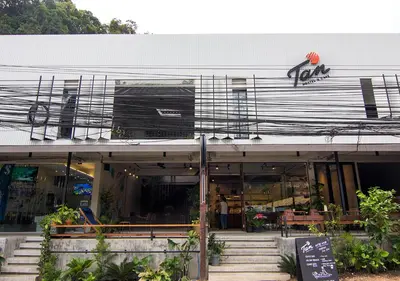 a store front with stairs in front of a building at TAN Hostel x Cafe , Aonang Beach in Ao Nang Beach