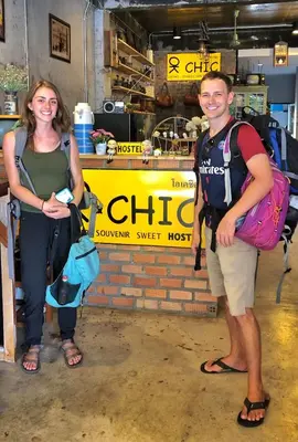 a man and a woman standing in front of a store at OK CHIC PHUKET HOSTEL in Phuket Town
