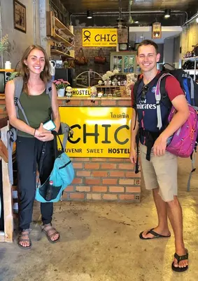 a man and a woman standing in front of a store at OK CHIC PHUKET HOSTEL in Phuket Town
