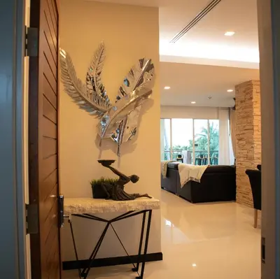 a living room with a large metal bird sculpture on the wall at Sunset Bliss in Klong Muang Beach