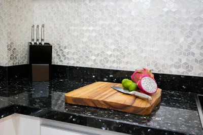 a cutting board with fruit on top of a kitchen counter at Sunset Bliss in Klong Muang Beach