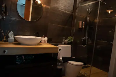 a bathroom with a sink and a toilet and a shower at Sunset Bliss in Klong Muang Beach