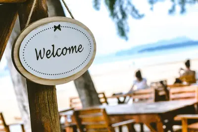 a sign that says welcome at a restaurant at Baan Tubkaek Hotel in Tab Kaek Beach