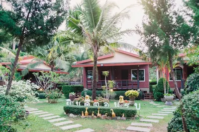 a house with a bunch of figurines in the yard at Siray Green Resort in Phuket Town
