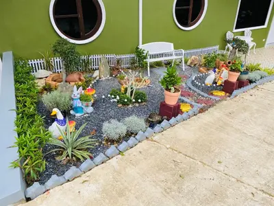 a miniature garden in front of a house at Siray Green Resort in Phuket Town