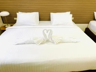 two swans made out of towels on a bed at Siray Green Resort in Phuket Town
