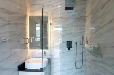 a bathroom with a shower with a sink and a toilet at Oceana Sea View Apartments - Kamala Beach in Kamala Beach