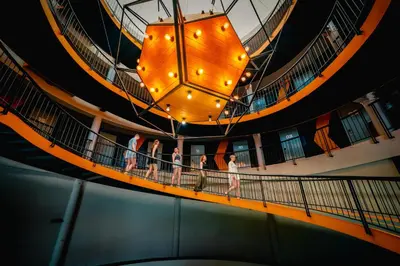 a group of people walking on a balcony on a ship at Hivetel Phuket in Chalong