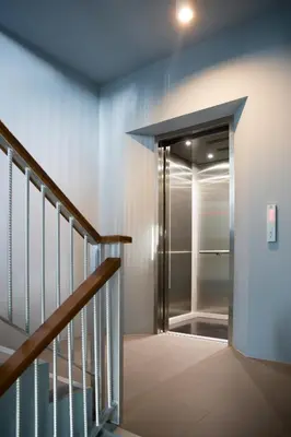 a hallway with a staircase and a glass door at iNest Poshtel in Kata Beach