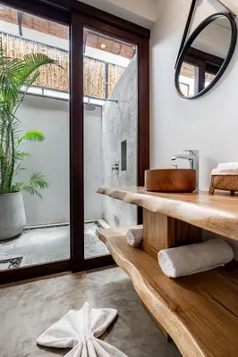 a bathroom with a wooden sink and a mirror at Cho Fah Residence in Ko Yao Noi