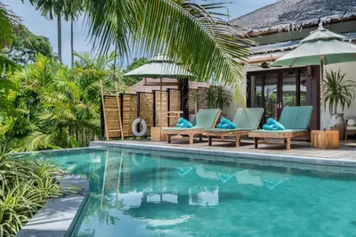 a villa with a swimming pool in a resort at Cho Fah Residence in Ko Yao Noi
