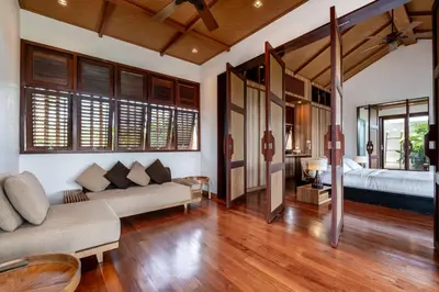 a living room with a couch and a bed in a room at Cho Fah Residence in Ko Yao Noi