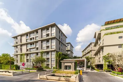 an apartment building on a street next to a road at Diamond Condominium Bangtao Beach in Bang Tao Beach